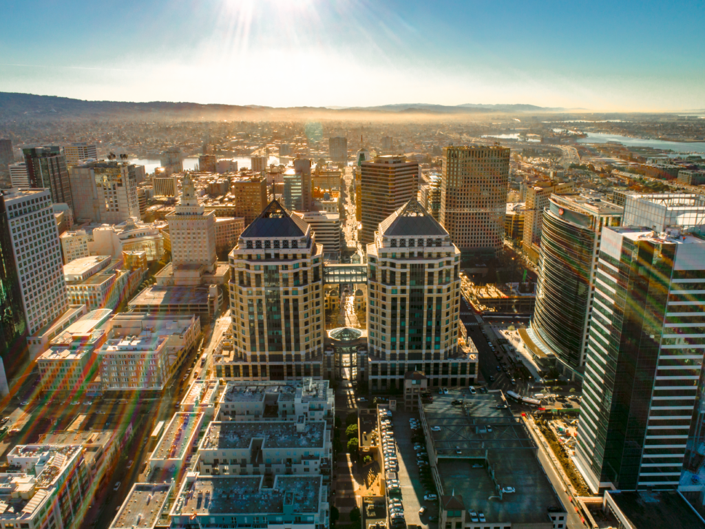 Aerial view of downtown Oakland skyline at sunrise — personal injury attorney John J. Roach serves accident victims throughout Oakland and the East Bay