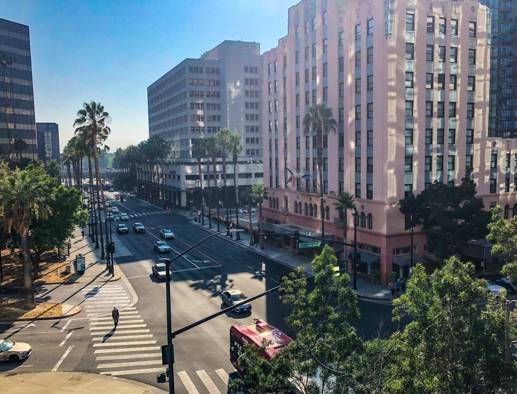 Downtown San Jose street intersection with pedestrian crossing and city buildings — personal injury attorney John J. Roach serves accident victims throughout San Jose and Santa Clara County