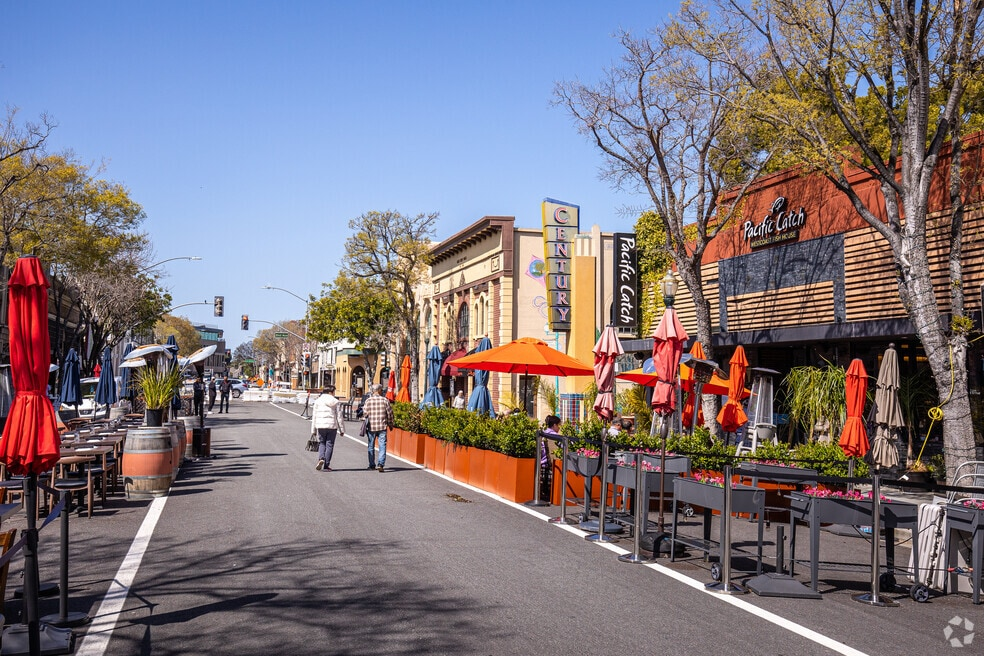 Downtown San Mateo street with outdoor dining and shops on a sunny day — personal injury attorney John J. Roach serves accident victims throughout San Mateo and San Mateo County