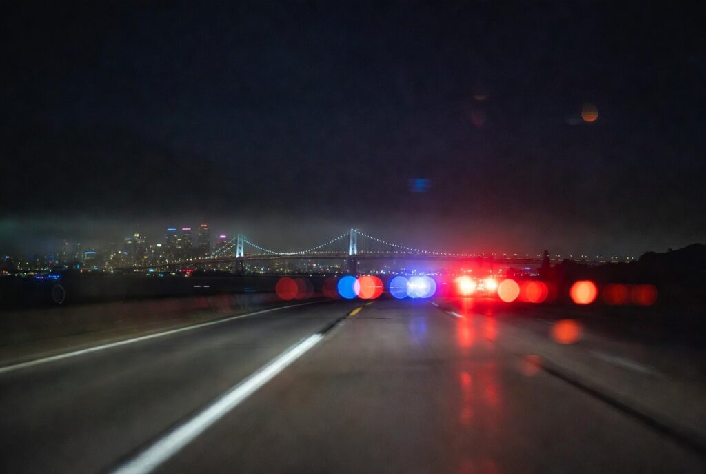 Emergency lights on a Bay Area highway at night — DUI accident attorney for victims of holiday weekend drunk driving crashes