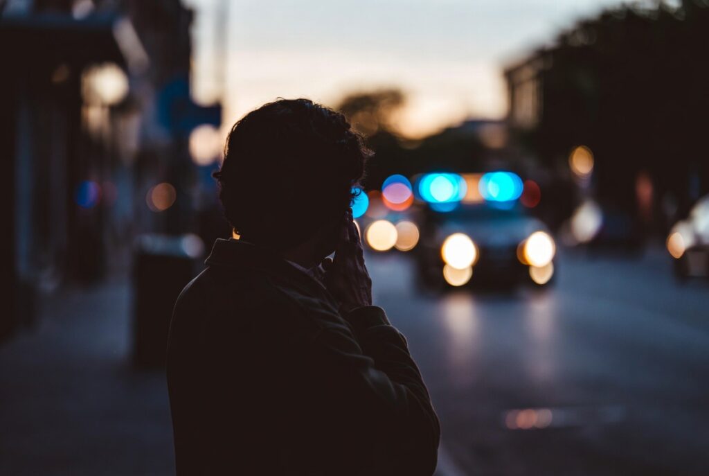 Family member witnessing the scene of a California accident from a distance.