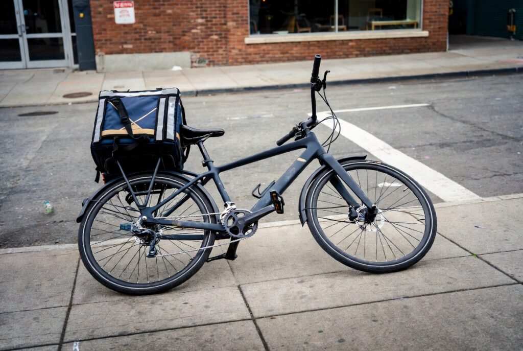 Damaged bicycle and delivery bag after a San Francisco eBike delivery rider accident