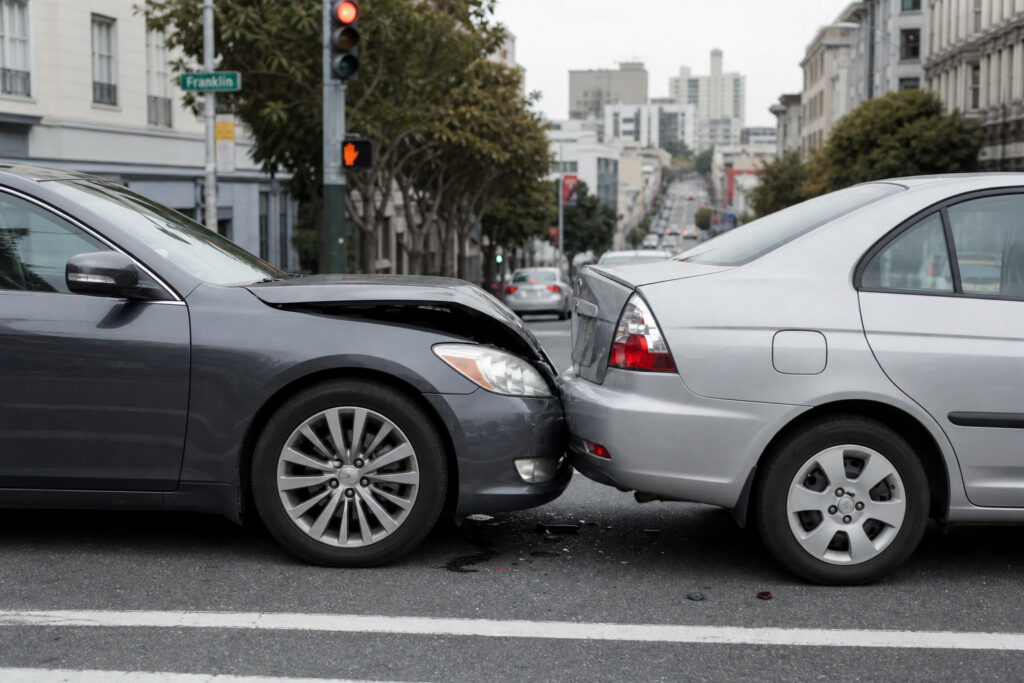 Choque por alcance a baja velocidad entre dos sedanes en una intersección con semáforo en rojo en San Francisco