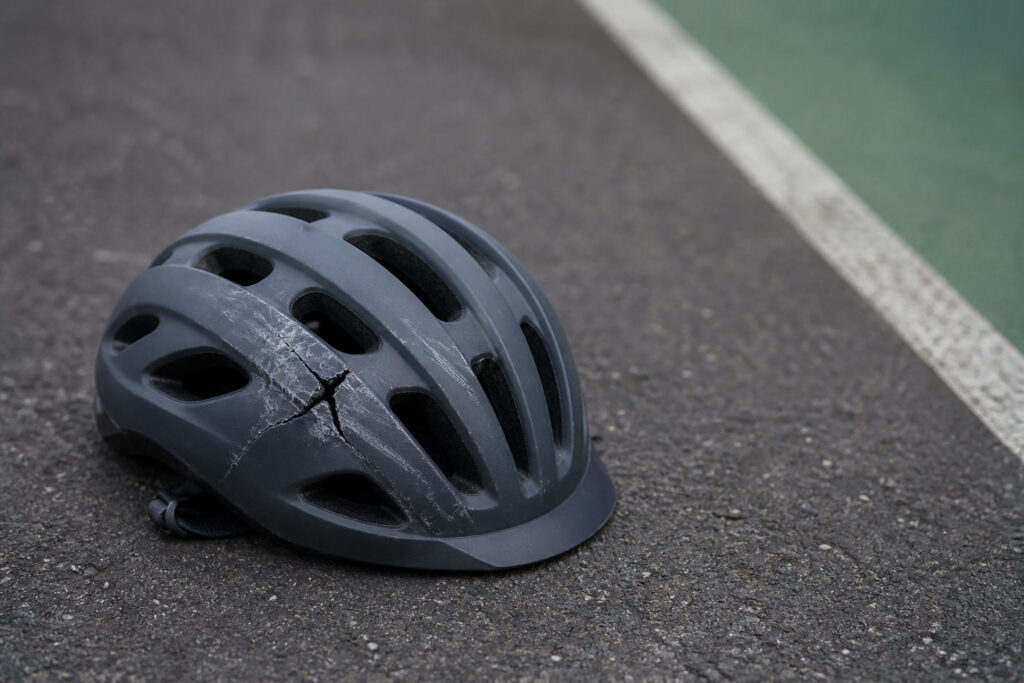 Generic cracked bicycle helmet illustrating a head impact in a bicycle collision