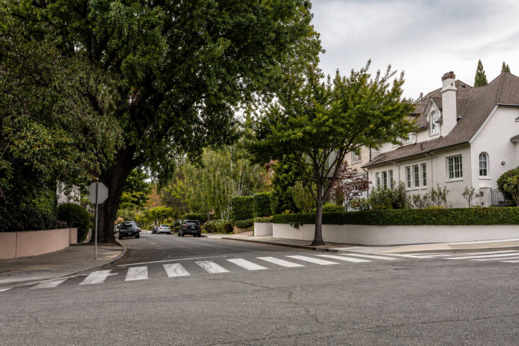 Painted crosswalk on a tree-lined Piedmont residential street