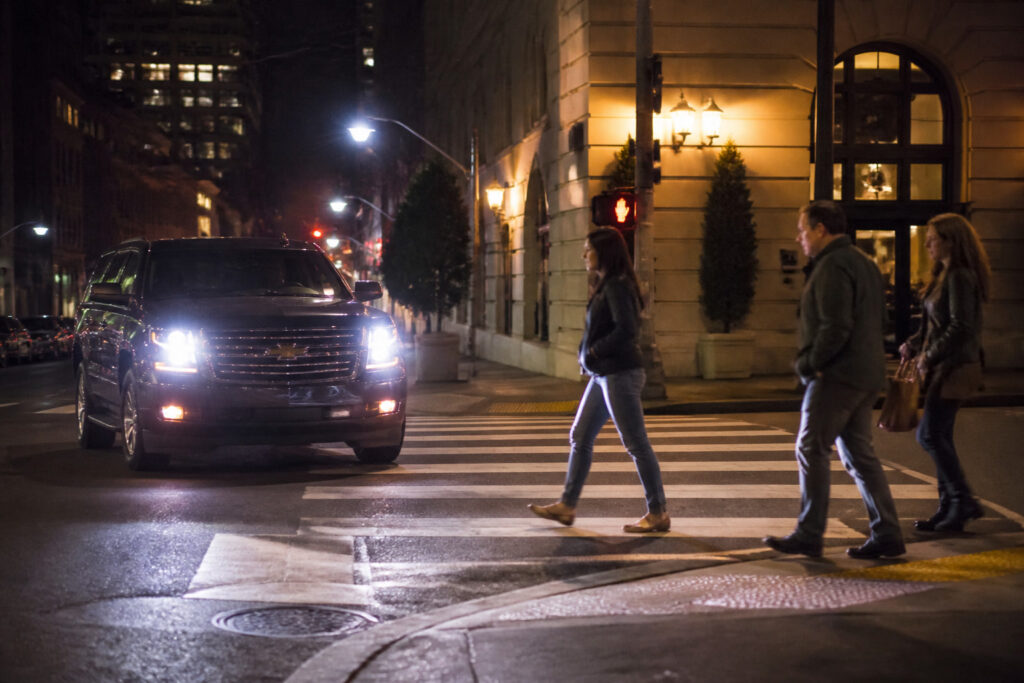 SUV at a San Francisco crosswalk after dark